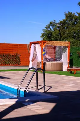 a slide in a pool next to a tent at Villa Crystal in Bihać