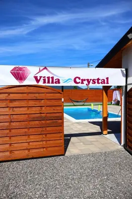 a wooden fence with a sign on top of a pool at Villa Crystal in Bihać