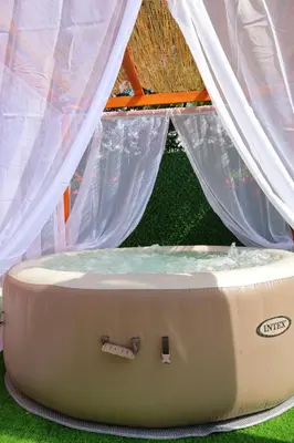 a mattress in front of a tent with curtains at Villa Crystal in Bihać