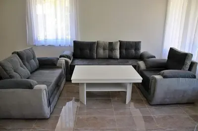a living room with a couch and a coffee table at Vikendica Gajić in Šipovo