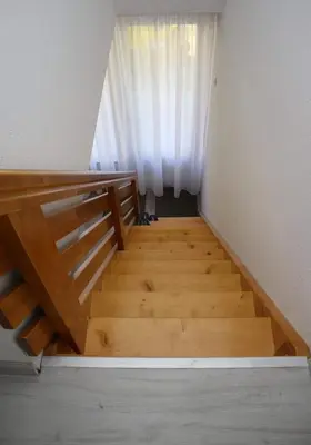 a room with a wooden staircase with a window at Vikendica Gajić in Šipovo