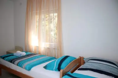 a small bed in a room with a window at Vikendica Gajić in Šipovo