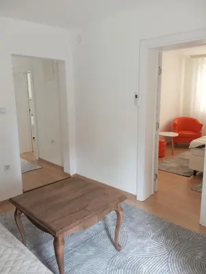 a living room with a wooden coffee table in it at Apartmani Mušinbegović in Visoko