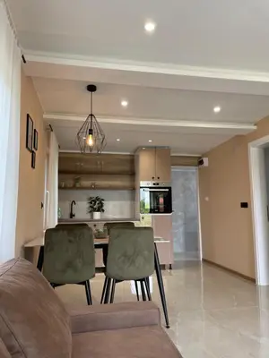 a kitchen with a table and chairs in a room at Bungalovi Izvor Plive in Šipovo