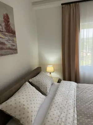 a bedroom with a bed and a window at Bungalovi Izvor Plive in Šipovo