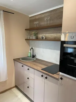 a kitchen with a sink and a stove top oven at Bungalovi Izvor Plive in Šipovo