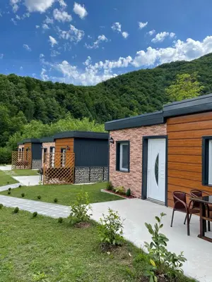 a group of modular homes with a patio and grass at Bungalovi Izvor Plive in Šipovo