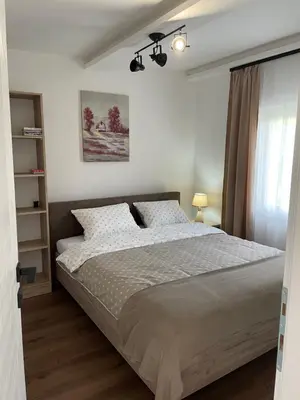 a bedroom with a large bed and a window at Bungalovi Izvor Plive in Šipovo