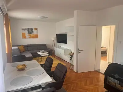 a living room with a couch and a table with chairs at Appartement Nada in Bosanski Brod