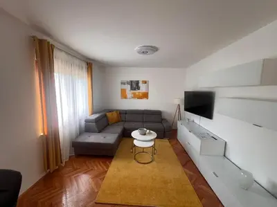 a living room with a couch and a table at Appartement Nada in Bosanski Brod