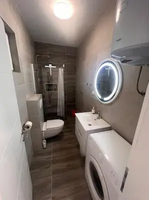 a bathroom with a sink and a toilet and a mirror at Appartement Nada in Bosanski Brod