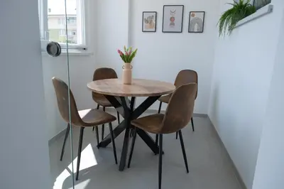 a table and four chairs in a room at Apartment Milla in Tomislavgrad