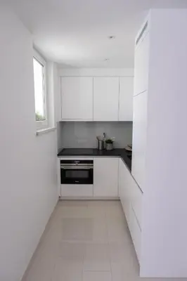 a white kitchen with white cabinets and a window at Apartment Milla in Tomislavgrad
