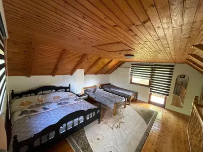 an aerial view of a bedroom with a bed and a couch at Villa Enigma in Bihać