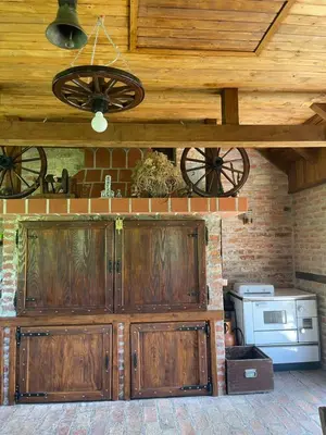 a kitchen with wooden cabinets and a wooden ceiling at Villa Enigma in Bihać
