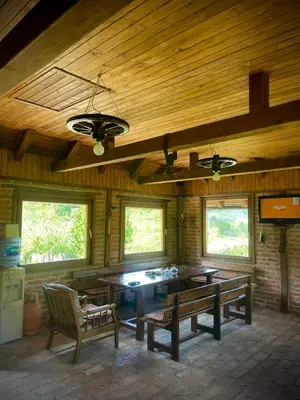 a dining room with a table and two benches at Villa Enigma in Bihać
