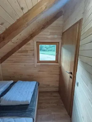 a small bedroom with a bed and a window at Vikendica Ana in Šipovo
