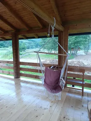 a hammock hanging from a roof in a porch at Vikendica Ana in Šipovo