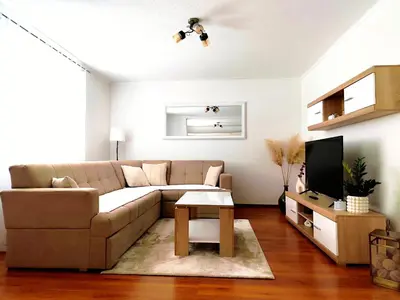 a living room with a couch and a tv at Apartman Dream in Livno