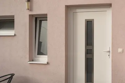 a house with a white door and windows at Apartman Dream in Livno