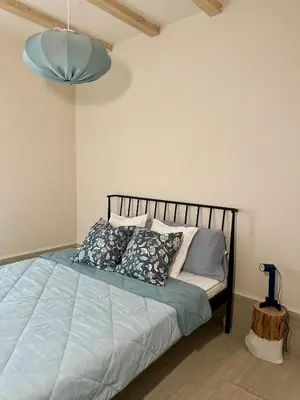 a bedroom with a bed with pillows on it at Kuca Oste in Banja Luka