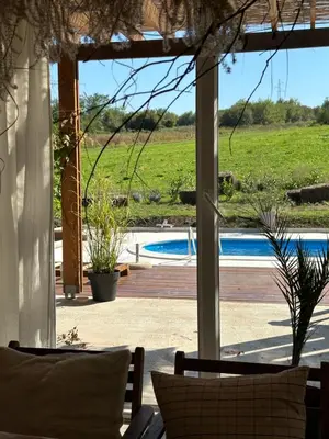 a view of a pool from the porch of a house at Kuca Oste in Banja Luka