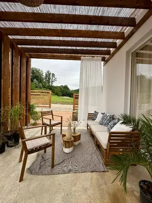 a patio with a couch and a table and chairs at Kuca Oste in Banja Luka