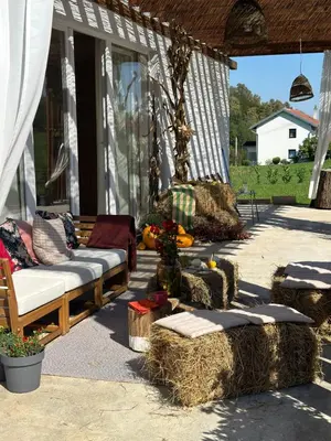 a patio with a couch and some hay bales at Kuca Oste in Banja Luka
