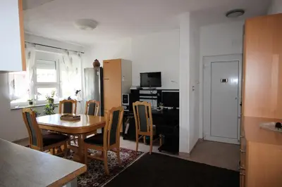 a kitchen and dining room with a table and chairs at Apartman Mak in Bihać