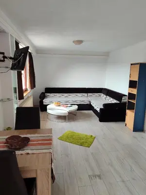 a living room with a couch and a table at Apartmani Nadi in Tuzla