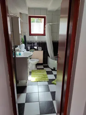a bathroom with a sink and a toilet and a tub at Apartmani Nadi in Tuzla