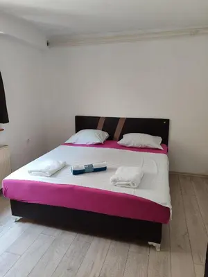 a large bed with two bottles on top of it at Apartmani Nadi in Tuzla