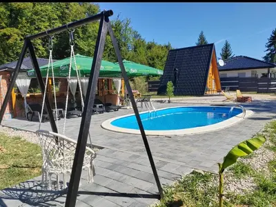 a swing in a yard with a swimming pool at Jerry's Forest in Banja Luka