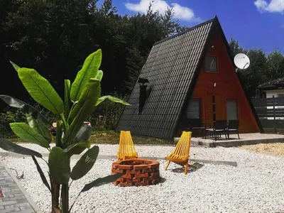 a small house with two chairs and a tree at Jerry's Forest in Banja Luka