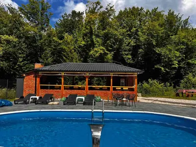 a house with a swimming pool in front of it at Jerry's Forest in Banja Luka