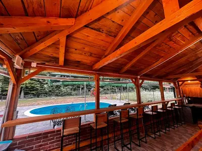 a large wooden ceiling with a pool in a house at Jerry's Forest in Banja Luka