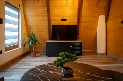 a living room with a television and a table at Jerry's Forest in Banja Luka