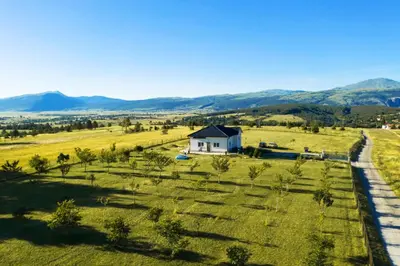 a house in the middle of a field with a road at Vila Anamari in Livno