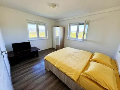 a bedroom with a bed and a television in it at Vila Anamari in Livno