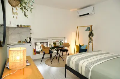 a bedroom with a bed and a table with chairs at ZenDen in Jajce