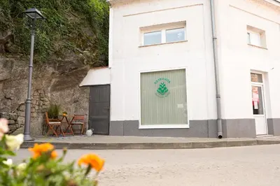 a white building with a sign on the side of it at ZenDen in Jajce