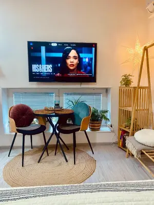 a living room with a table and a flat screen tv at ZenDen in Jajce