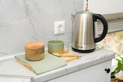 a coffee maker and two mugs on a counter at ZenDen in Jajce