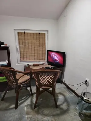a room with a desk with a computer and two chairs at VIKENDICA GARFILD SA BAZENOM i SAUNOM BANJA LUKA in Banja Luka