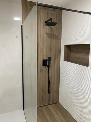 a shower with a wooden door in a bathroom at Villa La Casa -Family house in Jajce