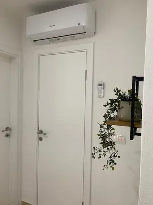 a white door in a room with a plant at Villa La Casa -Family house in Jajce