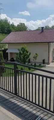 a house with a fence in front of it at Villa La Casa -Family house in Jajce