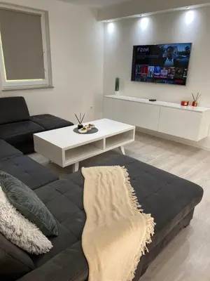 a living room with a couch and a tv on the wall at Villa La Casa -Family house in Jajce