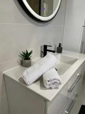 a white bathroom sink with a towel on it at Villa La Casa -Family house in Jajce