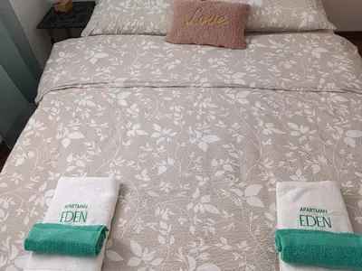 a bed with two pillows on top of it at Apartman EDEN in Jajce